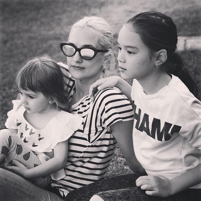 Carla Ruffino with her daughters in a black and white photo filter.